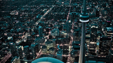 An aerial night view of Toronto with the CN Tower and Rogers Centre