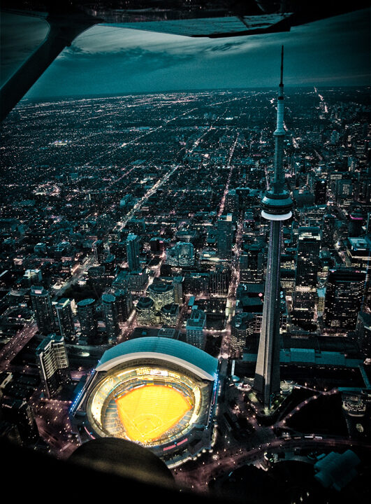 An aerial night view of Toronto with the CN Tower and Rogers Centre