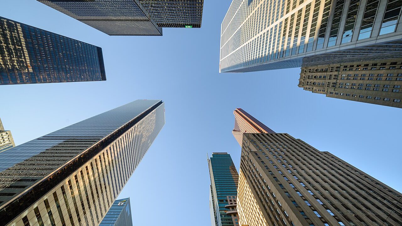 Office towers of the Toronto financial district seen from below against a clear sky
