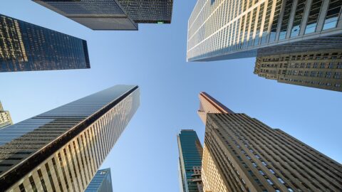 Office towers of the Toronto financial district seen from below against a clear sky