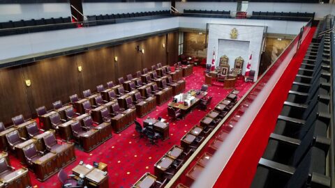 The temporary Senate of Canada chamber with red carpet and empty desks