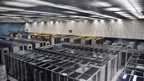 Rows of server racks inside a large data centre hall