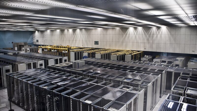 Rows of server racks inside a large data centre hall