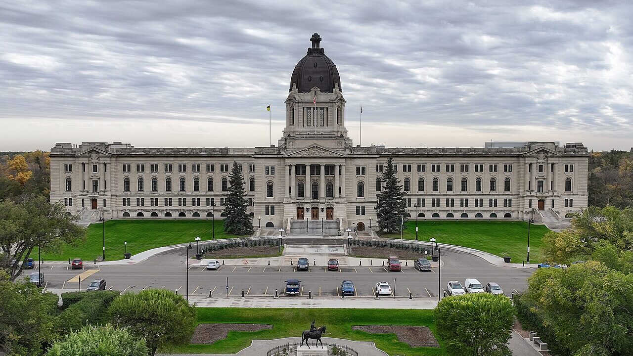 The Saskatchewan Legislative Building in Regina with lawns and parked cars in front