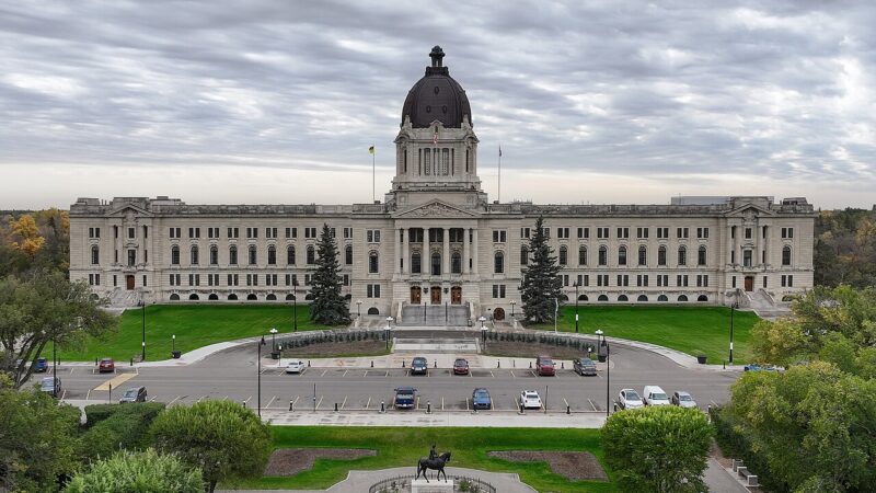 The Saskatchewan Legislative Building in Regina with lawns and parked cars in front