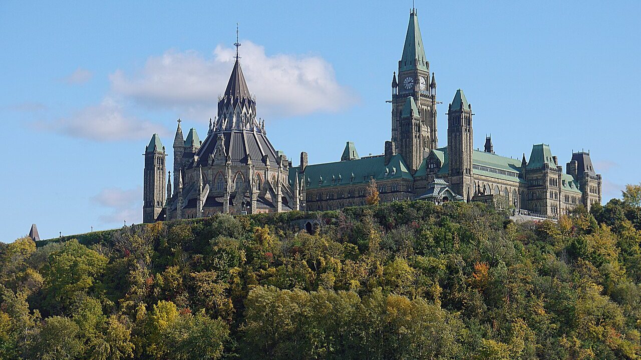 Parliament Hill and the Peace Tower seen across the Ottawa River in autumn
